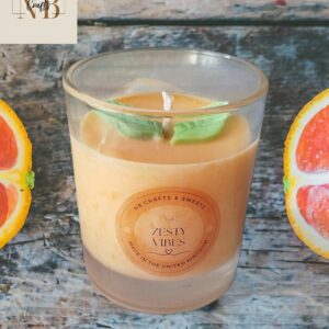 Orange scented candle in a glass jar